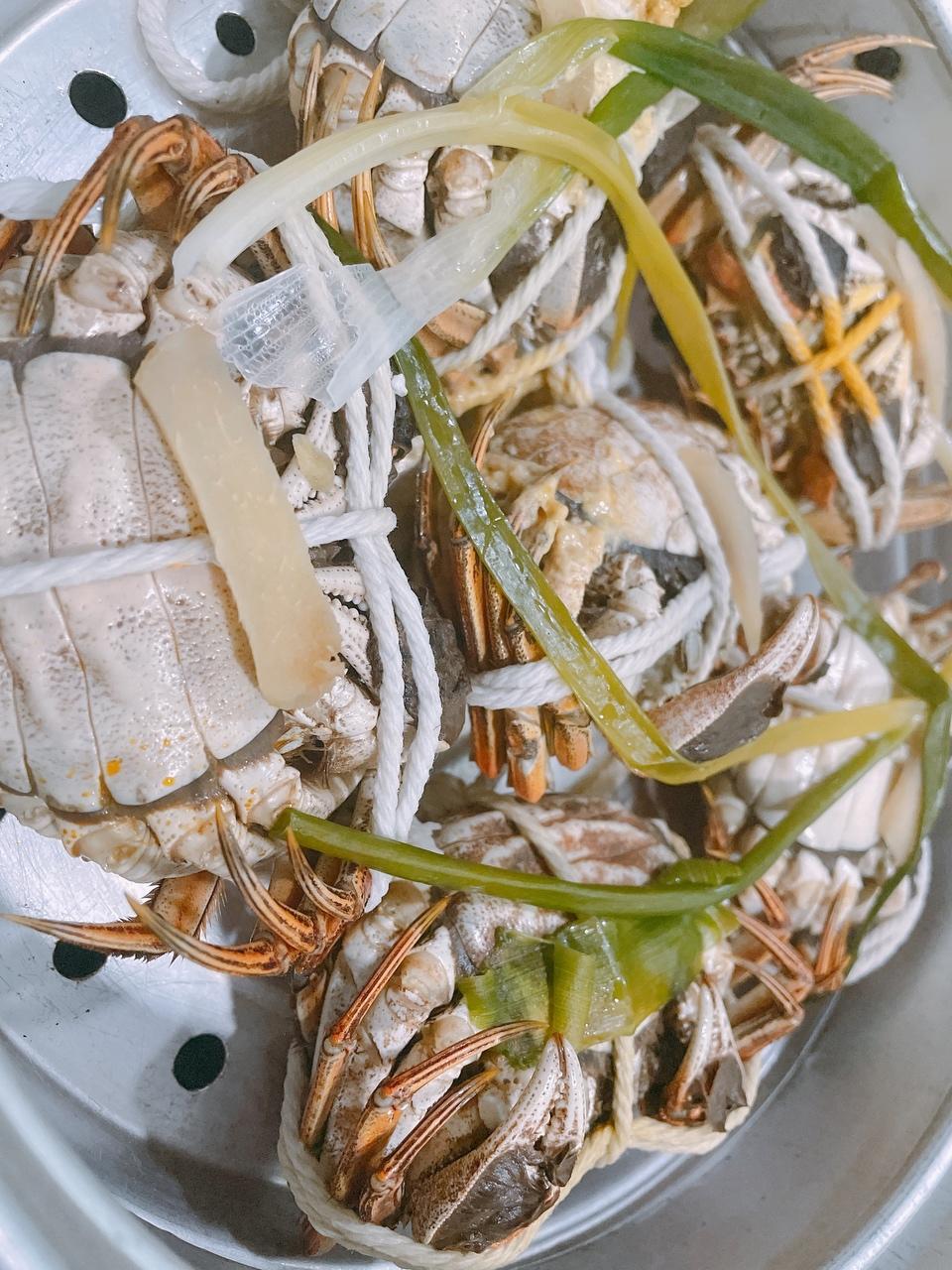 蟹肚朝上,放姜片,葱段水开放入螃蟹,上汽蒸20min,大火水里加入料酒,葱